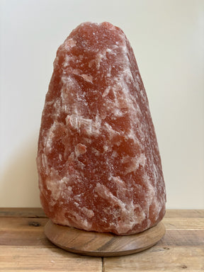 Himalaya zoutlamp 12-15kg, groot formaat met warme, natuurlijke gloed, op stevige houten voet.